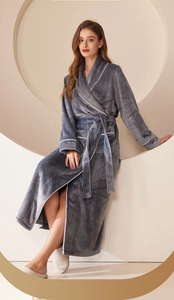 Detail of dark gray flannel robe featuring white piping and soft plush texture