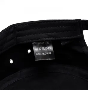 Detail view of the 100% cotton fabric label and interior stitching of the black military cap
