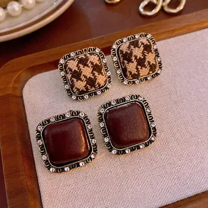 Vintage gold square stud earrings with houndstooth fabric and sparkling rhinestones