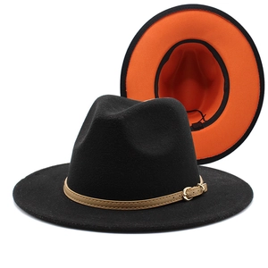 Detail of classic black wool fedora featuring a vibrant orange lining and leather band