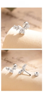 Macro detail of silver butterfly stud earring with sparkling marquise zircon wings