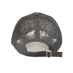 Close-up of black lace baseball cap back with heart patterns and gold metal buckle