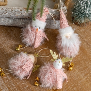 Pink plush Christmas ornaments with Santa, snowman, elk, and bells on a wooden desk