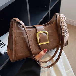 Brown crocodile pattern shoulder bag with gold buckle and checkered silk scarf accent
