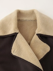 Detail of faux sheepskin collar and beige wool lining on dark brown vintage coat