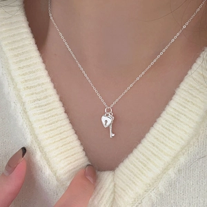 Elegant 925 sterling silver heart lock and key pendant necklace on a knit sweater