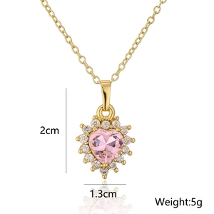 Detail view of 18K gold heart pendant with pink zircon showing dimensions 2cm by 1.3cm