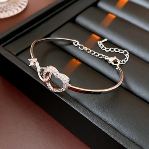 Detailed view of silver heart bracelet with interlocking zircon heart and lobster clasp