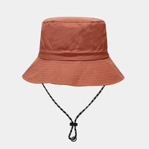 Detail of rust red waterproof sun hat featuring adjustable black and white chin strap