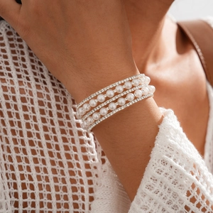Close-up of elegant multi-layer pearl and rhinestone bracelet worn on female wrist