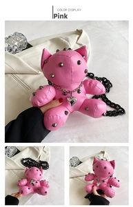 Close-up of pink punk doll crossbody bag with silver metallic studs and chain details