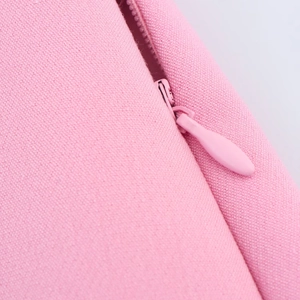 Close-up of a pink skort with high-quality concealed zipper and textured fabric detail