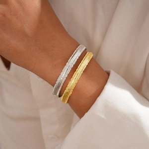 18k gold plated geometric textured bangle with horizontal stripes for a minimalist style