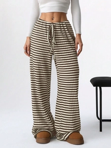 Detail of high waisted striped knit trousers with elastic drawstring and brown stripes