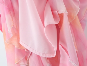 Detail of pink floral gradient chiffon fabric featuring layered ruffle edges and stitching