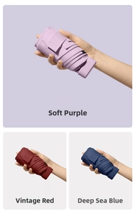 Three compact travel umbrellas in purple, vintage red, and deep blue shown folded