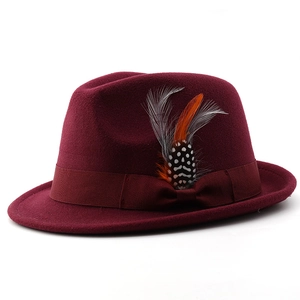 Close-up of burgundy wool fedora hat featuring a satin bow and decorative feathers