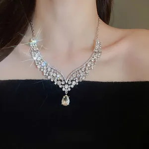 Elegant silver V-shaped necklace set with sparkling rhinestones and a large teardrop pendant