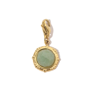 Detail of light green natural stone pendant with gold lobster clasp and beaded bezel