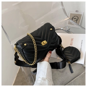 Detail of black chevron quilted chain bag with wide strap and round coin purse accessory