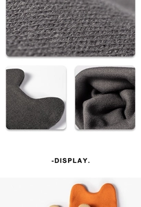 Macro detail of fine knit texture and 3D ear shape on gray and orange winter beanies