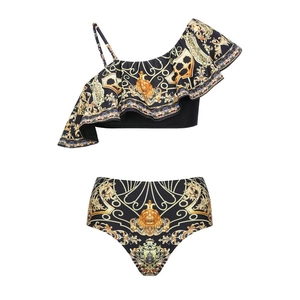 Detail of baroque gold leaf print on black one-shoulder ruffled bikini with lion emblem