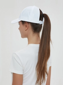 Rear view of a white baseball cap with ponytail cutout design and adjustable strap