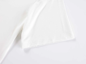 Detailed close-up of white cotton T-shirt sleeve with high-quality double-stitch sewing