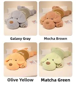 Plush dog dolls in four colors wearing Happy sweaters on a cozy bed setup
