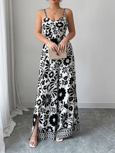 Elegant wide-leg jumpsuit with black and white floral print and delicate strap detail