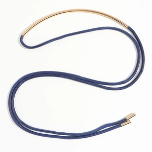 Detail of blue braided rope necklace with curved gold metal tube and elegant S-shape