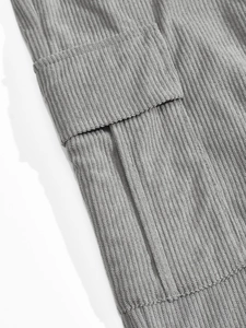 Detailed close-up of grey corduroy texture and a functional pocket on the casual suit