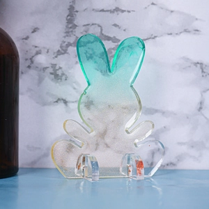 Macro view of rabbit silicone mold with green gradient finish and golden glitter texture