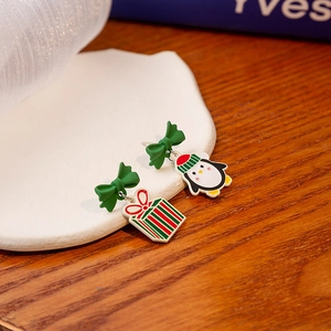 Festive Christmas earrings featuring enamel penguin and holiday gift box charms