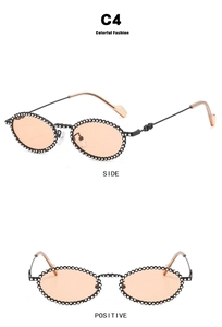 Close-up of C4 oval sunglasses with diamond-encrusted black frame and orange lenses