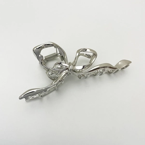 Detail shot of silver metallic bow-shaped hair claw clip with durable spring mechanism