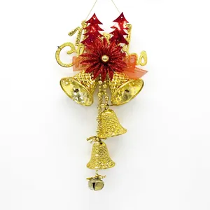 Detail of Christmas tree hanging decoration with gold bells and red glitter ornaments