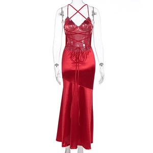 Detail of red satin backless dress with cross-strap design and smooth silky texture