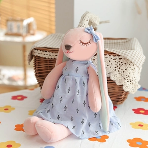 Pink plush rabbit doll in a light blue tree pattern dress with blue bow decoration