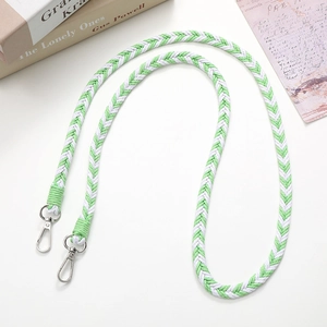Detail of green and white woven gradient shoulder strap with silver lobster clasps