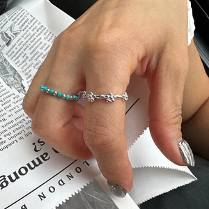Minimalist 925 sterling silver ring with small floral shapes and turquoise beads