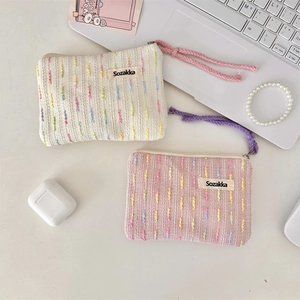 Detail of Sozakka mini makeup bag with woven texture, zipper cord and school supplies