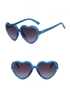 Detail of heart-shaped blue glitter sunglasses for kids with grey lenses and clear frames