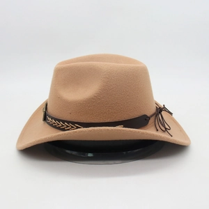 Close-up of camel wool cowboy hat featuring brown leather band with embroidery details