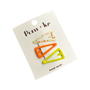 Set of three colorful triangle hair clips in orange, yellow and floral patterns