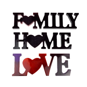 FAMILY HOME LOVE resin letters with glossy finish and heart designs on white background