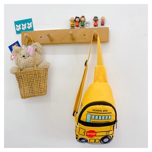 Detail of yellow school bus chest bag with cute cartoon stop sign and fabric strap
