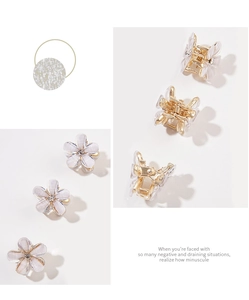Detailed view of mini crystal flower hair claws with pearlescent petals and gold base