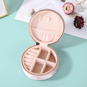 Pink velvet circular jewelry organizer with rings slots and necklace hooks storage