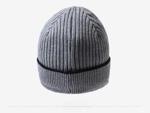 Detail view of the thick ribbed texture and contrasting black trim on this grey beanie